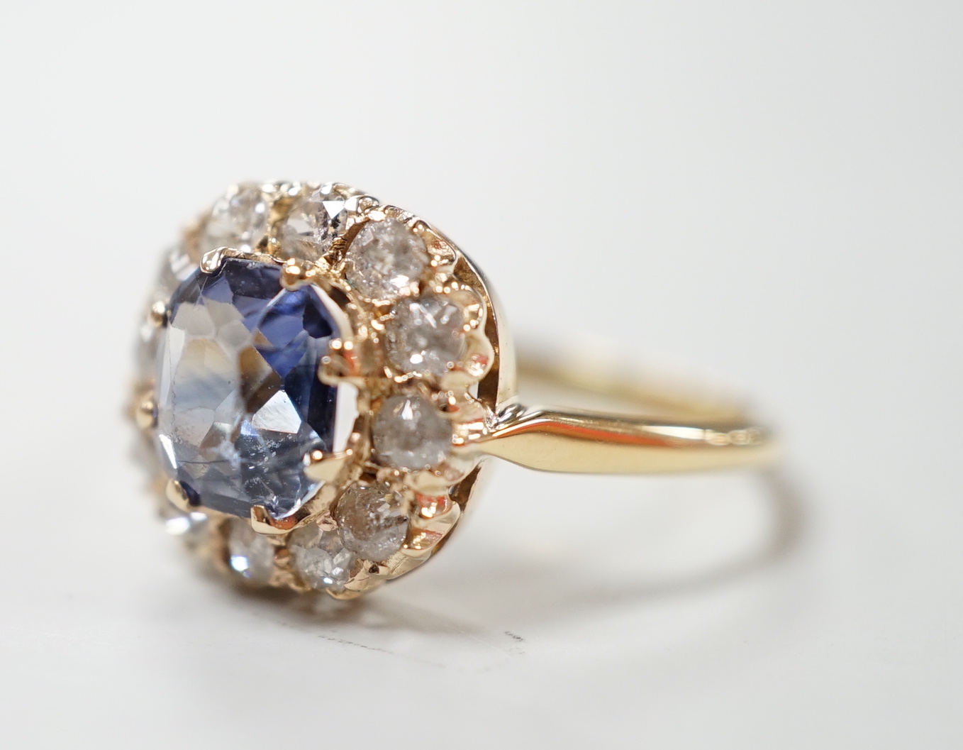 An 18ct, sapphire and diamond set cluster ring, size M, gross weight 3 grams.